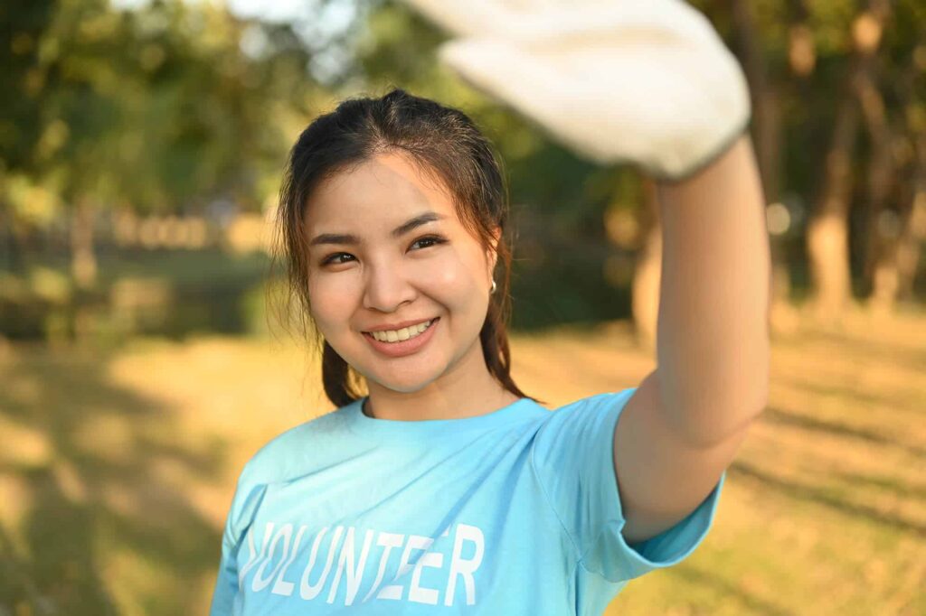 positive-asian-female-volunteer-cleaning-up-nature-2024-01-09-12-49-38-utc.jpg